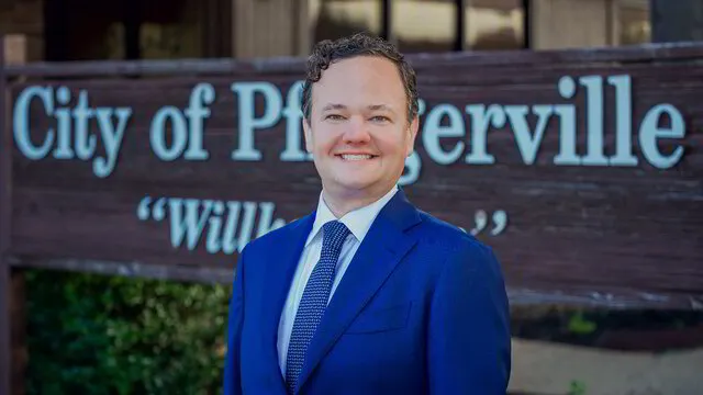 Jonathan Coffman standing in front of city hall in Pflugerville