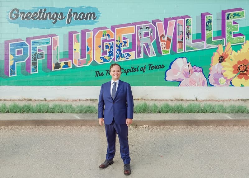 Jonathan Coffman in front of a Pflugerville mural